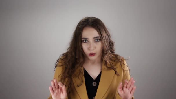 Young caucasian woman is showing ok sign and breathing out to calm down in slowmo — Stock video