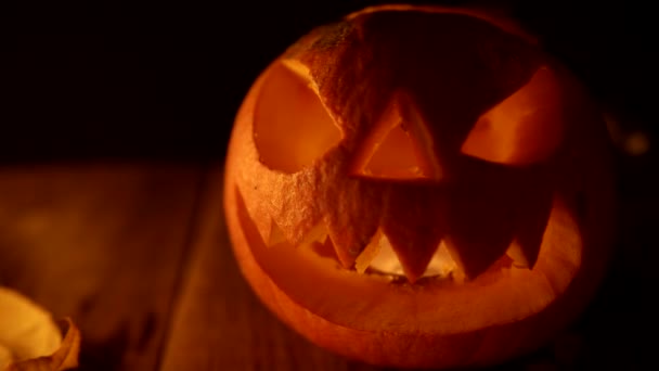 Blinking candle light coming from traditional jack-o-lantern — Stock Video