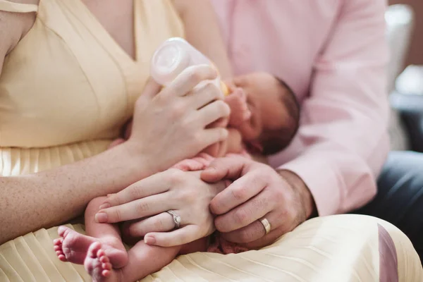 New parents holding newborn baby