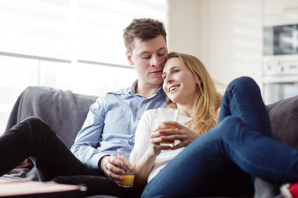 Couple enjoying themselves on the sofa — Stock Photo, Image