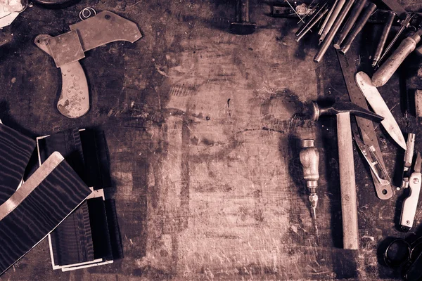 Leather crafting tools on working desk with the scratches — Stock Photo, Image