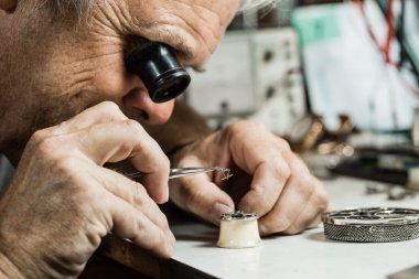 Clockmaker repairing wrist watch clipart
