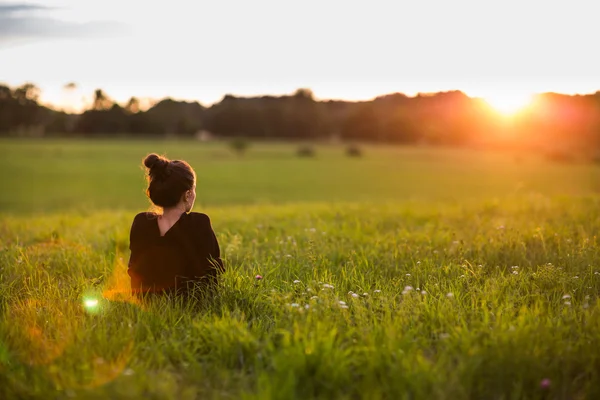 Mulher assistindo o pôr do sol — Fotografia de Stock