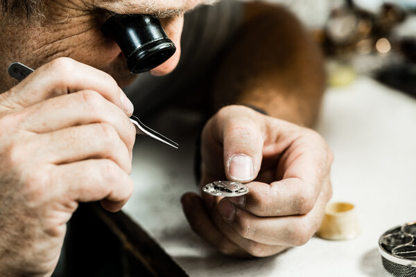 Clockmaker repairing  watch.