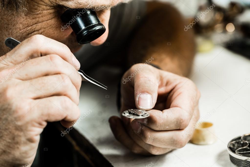 Clockmaker repairing  watch.