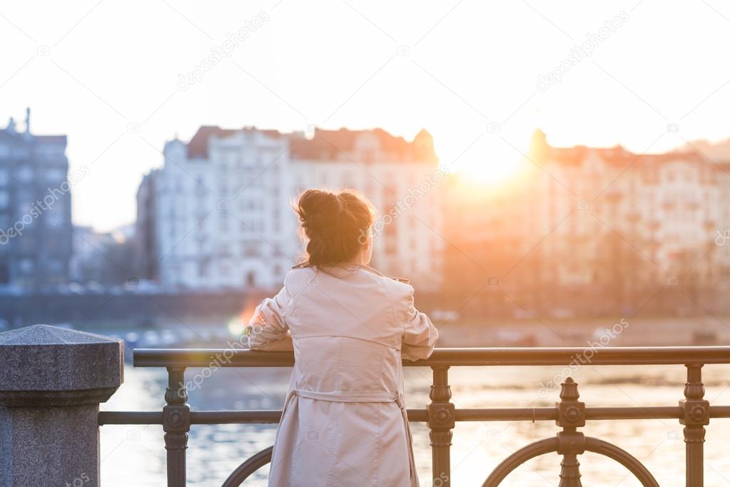 Woman is looking at the sunset