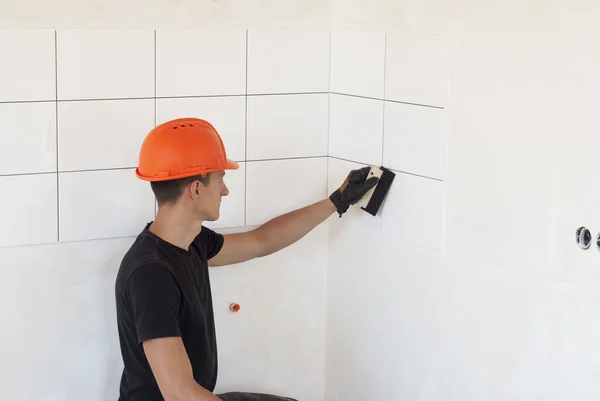 Laying ceramic tiles on a wall — Stock Photo, Image