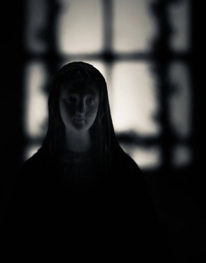 Karanlıkta bir kadın heykeli silueti