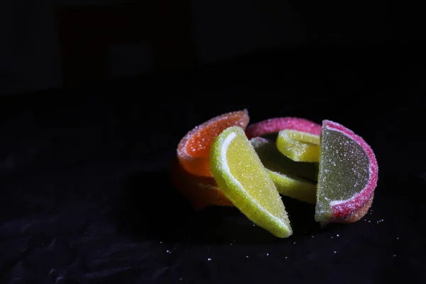 Schijfjes Zoete Gekleurde Marmelade Liggen Een Hoop Een Zwart Oppervlak — Stockfoto