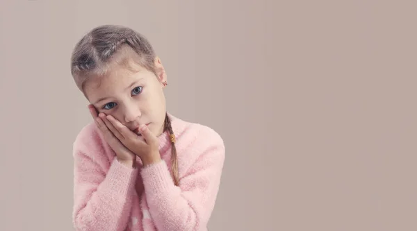 Little girl holding her cheek with her hands, her tooth hurts — Stock Photo, Image