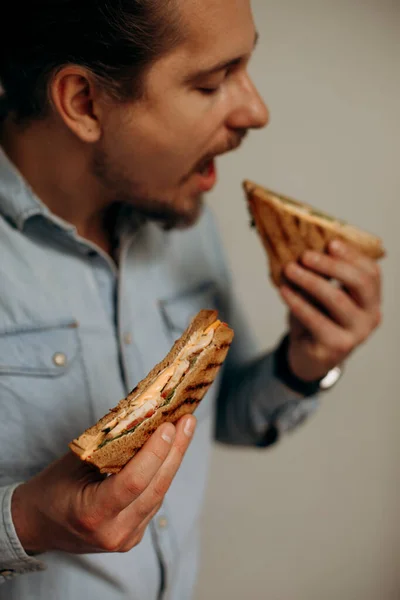 Seorang Pria Dengan Kemeja Denim Ingin Menggigit Sandwich Pemuda Yang — Stok Foto