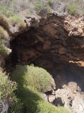 Tehlikeli uçurumlar keskin kayalarla çevrili kocaman bir deliğe bakıyor.