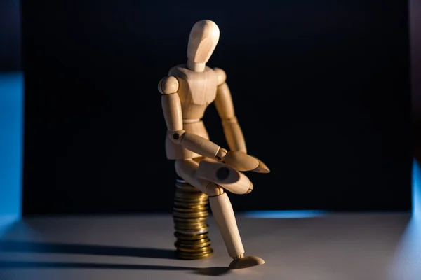 Wooden man toy figure with money on white background. Business concept.