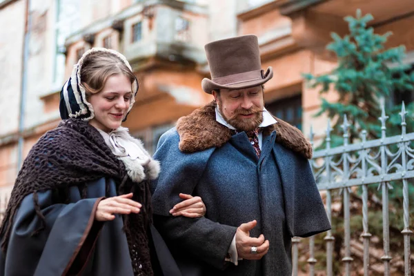 The woman and the man in vintage suits. People in retro dresses. Walking on the street