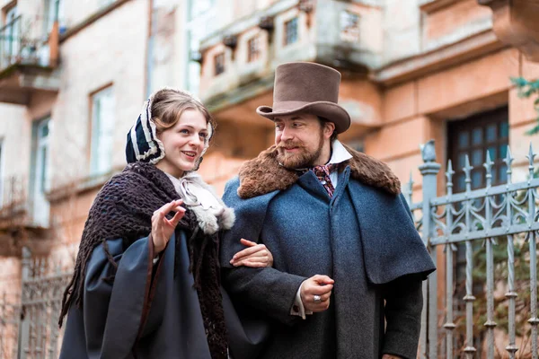 The woman and the man in vintage suits. People in retro dresses. Walking on the street