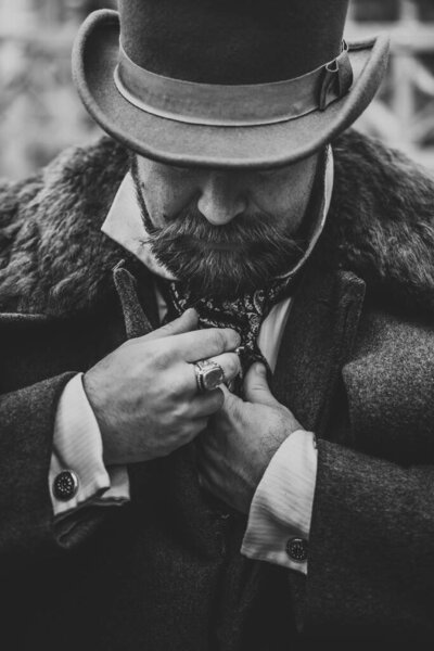 Elegant man. The gentleman in a coat and a top hat