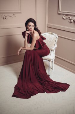 Güzel saç stili ve makyajlı, uzun, siyah bir gece elbisesi içinde güzel bir kadın.