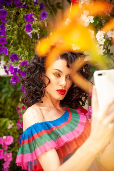 Beautiful woman in the flowers dress in summer city