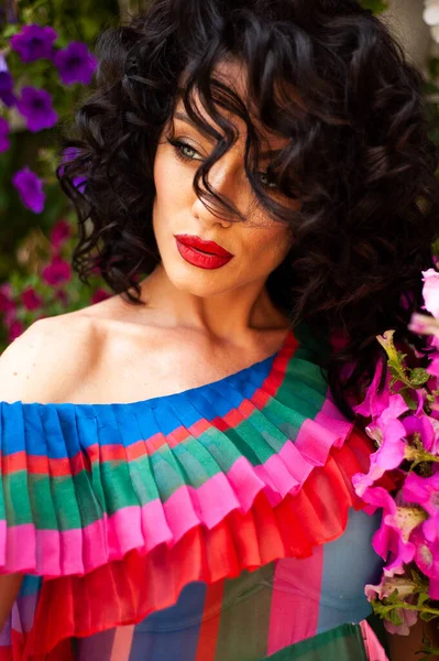 Beautiful woman in the flowers dress in summer city