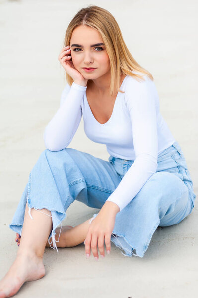 Woman on sand, casual clothes