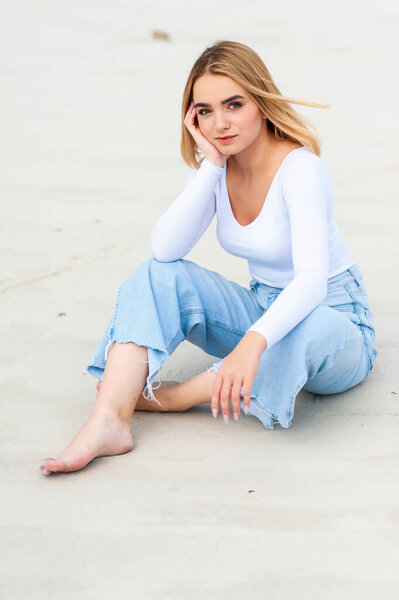 Woman on sand, casual clothes