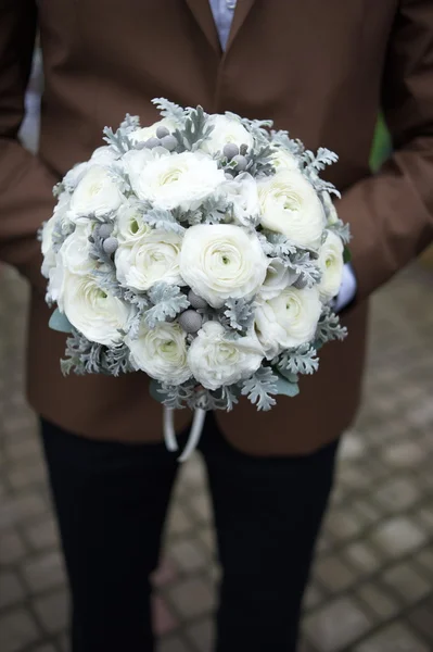 The groom in a suit or Young girl-bride or bridesmaid is holding a wedding bouquet — Stock Photo, Image