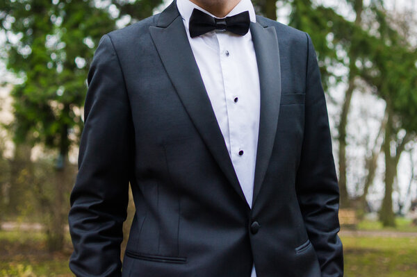 Beautiful bride in wedding dress preparing to ceremony in church. Walking near old castle