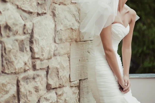 Bride walking near old castle before wedding ceremony — Stock Photo, Image