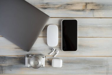 Items of modern technologies for working online and freelancing: laptop, mouse, smartphone, camera.