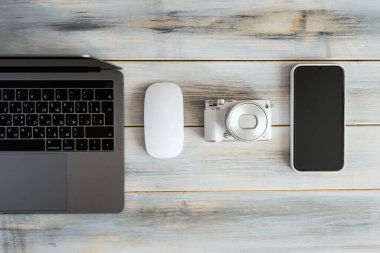Items of modern technologies for working online and freelancing: laptop, mouse, smartphone, camera.
