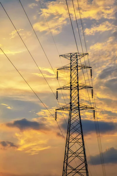 Yüksek gerilim elektrik pilon saat gün batımında.