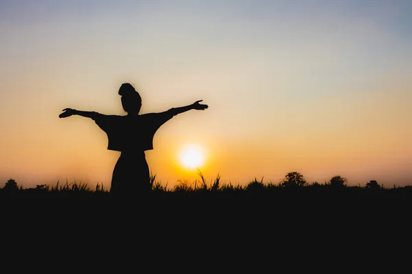 Silhouette de femme au coucher du soleil, Position debout, près de l'atmosphère tamisée — Photo