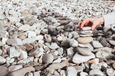 Bir insan taştan bir plaja taş kule inşa eder. Metin için yer