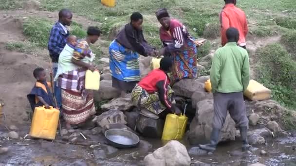 Localnicii colectează apă într-o singură sursă de apă din apropierea satului — Videoclip de stoc