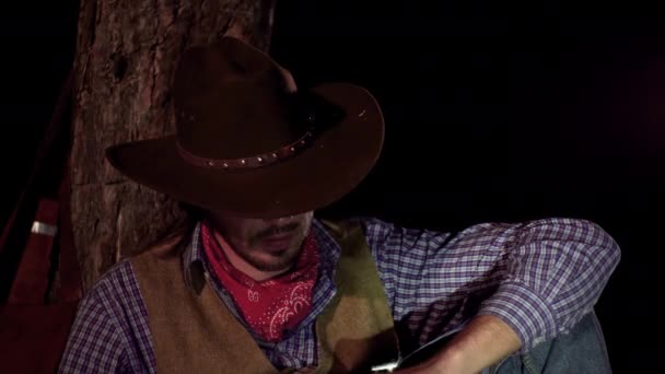 Cowboy met een sigaar in het bos 's nachts — Stockvideo