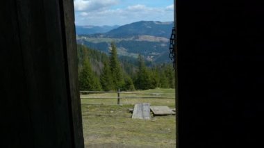 Dağ manzarasına bakan açık bir kapı.