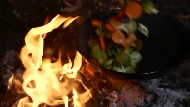 Faire frire le brocoli et les carottes dans une casserole sur un feu — Video