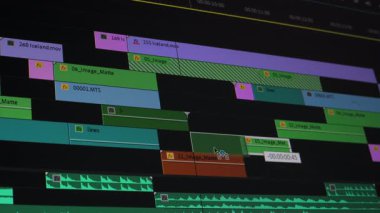 Profosyonel Yazılım Arayüzü 'ndeki Video Düzenleme Zaman Çizelgesi, Renkli Klipler ve Ses Parçaları Yapım sonrası bir video düzenleme zaman çizgisinde düzenlenmiştir