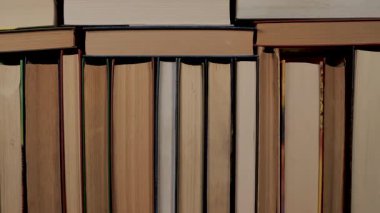 Kitaplar kütüphane ve eğitim konsepti için arkaplan dokusu, bilgi ve öğrenmeyi sembolize eden birbirine yakın duran ciltli kitaplar dizisi