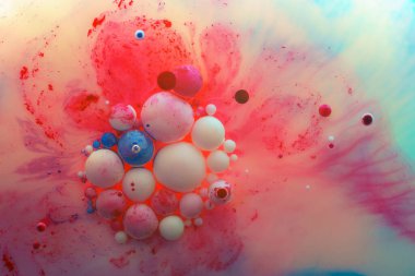 Overflows and bubbles of acrylic paint in liquid, many colors