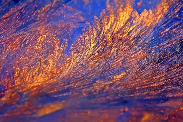 Ijzige frosty sierlijke patroon van dunne ijs op het venster op de achtergrond van de dageraad. — Stockfoto