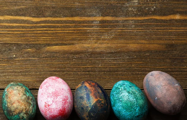 Easter eggs in the nest on wooden background. — Stock Photo, Image