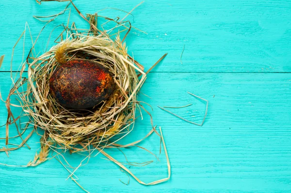 Easter eggs in the nest on wooden background. — Stock Photo, Image