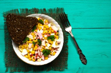 Yengeç ahşap bir masa üzerinde bir tabak salata. Rustik tarzı