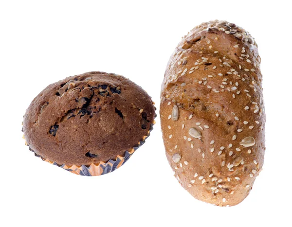 Muffin and a bun with seeds  on a white background — Stock Photo, Image