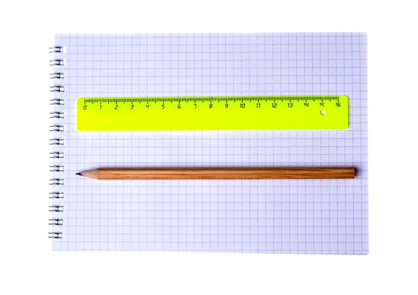 Ruler and pencil on notebook isolated on white background — 图库照片