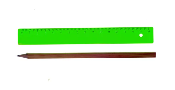 Green ruler and pencil isolated on white background — ストック写真