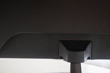 Close-up of a designer computer monitor seen from behind on a white table