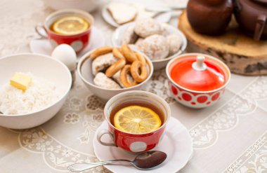 Traditional Russian or Ukrainian breakfast: eggs, rice porridge, honey, bagels (sushki) and tea with lemon. Traditional Russian or Belarusian cuisine. Russian traditional gingerbread cookies.