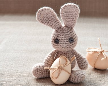 Easter bunny toy with easter eggs natural colour. Easter egg with ribbon. Vintage style easter  card